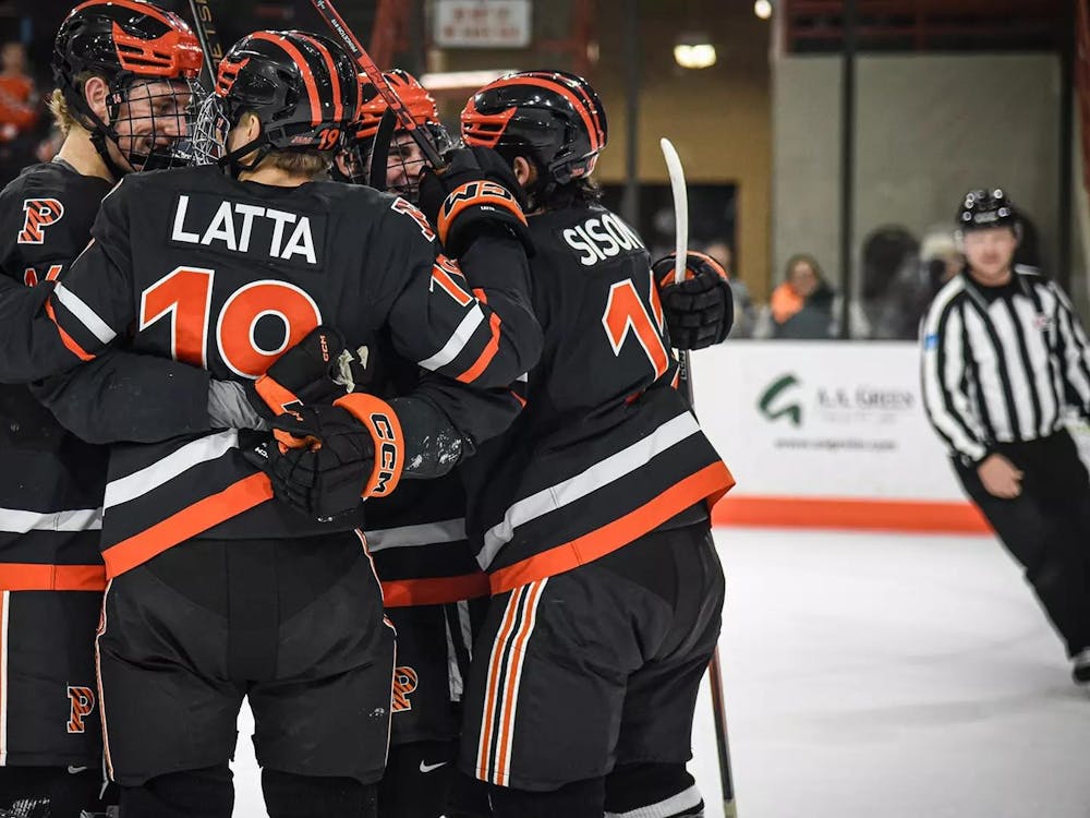 Ice hockey players huddling on rink.