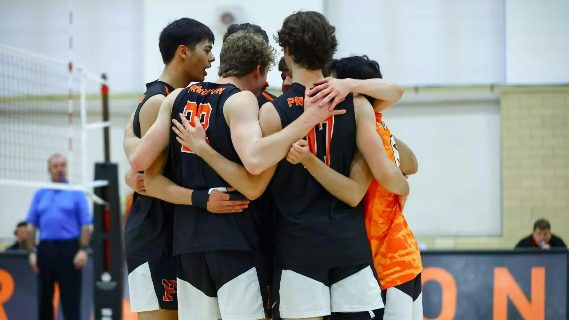 A group of volleyball players strategizing their next play.