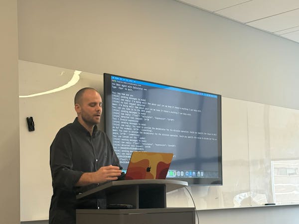 dr. joshua meyer speaking at AI event photo creds Morgan Dence.png