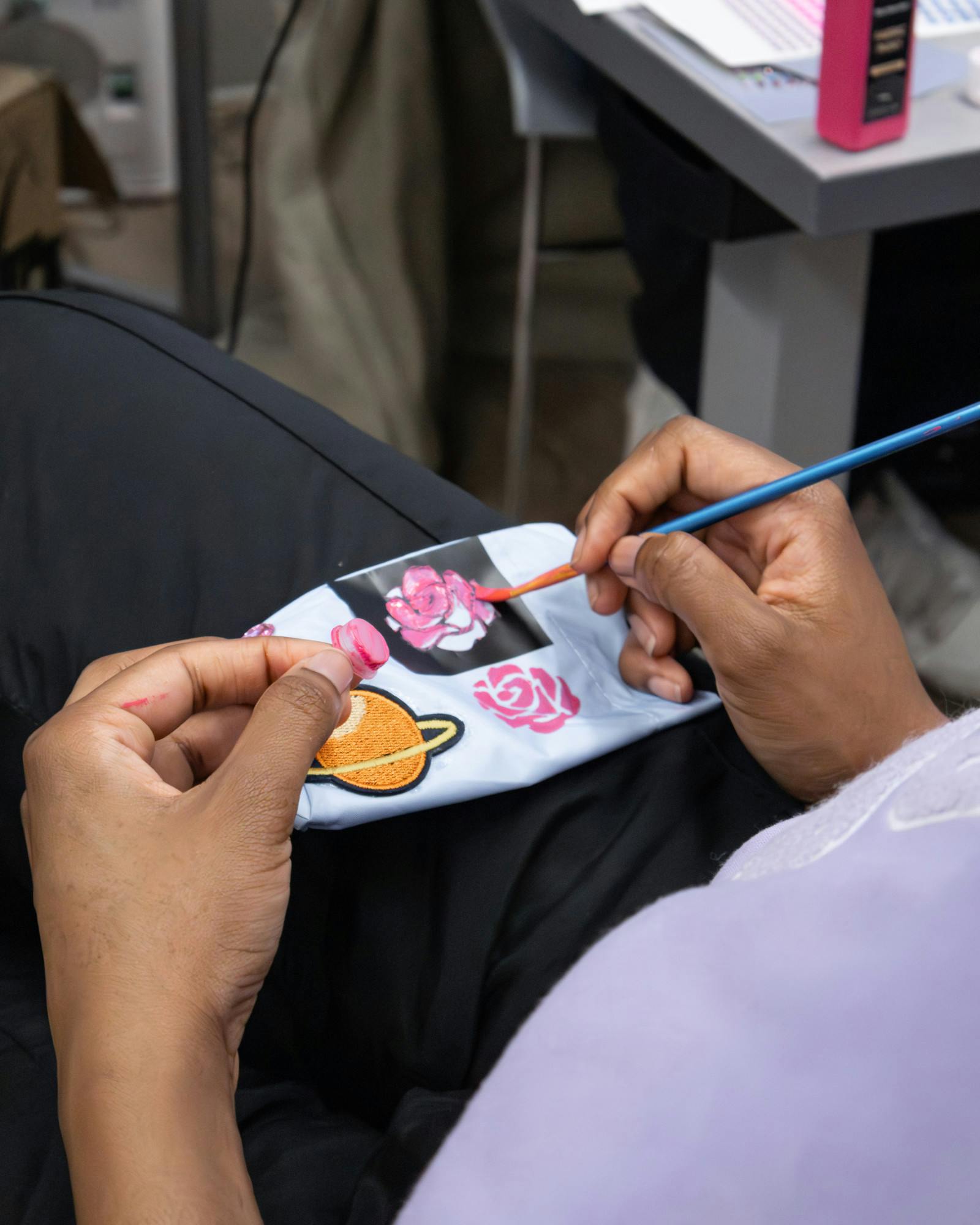 Students painting decals at Fashion Club's "Deck Out Your Denim" | Photo by Natalie Nojaim