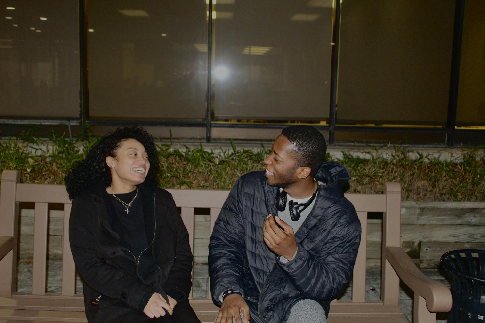 A couple sitting outside on a bench | Photo by Destiny Hartsfield