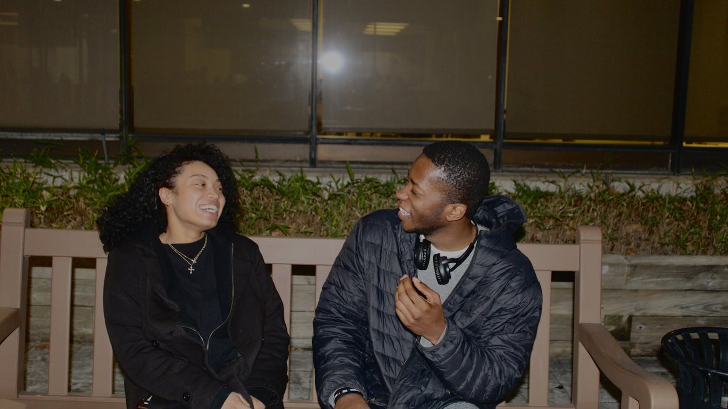 A couple sitting outside on a bench | Photo by Destiny Hartsfield