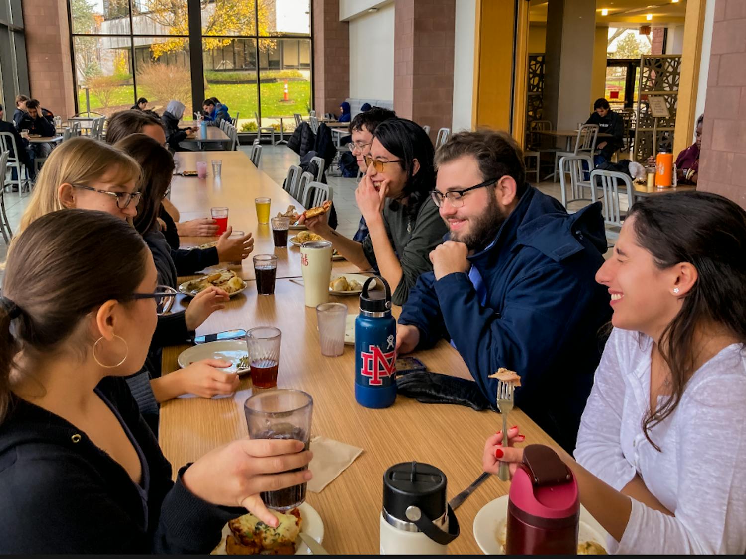 Students gather at a table for dinner | Photo by Elizabeth Denton
