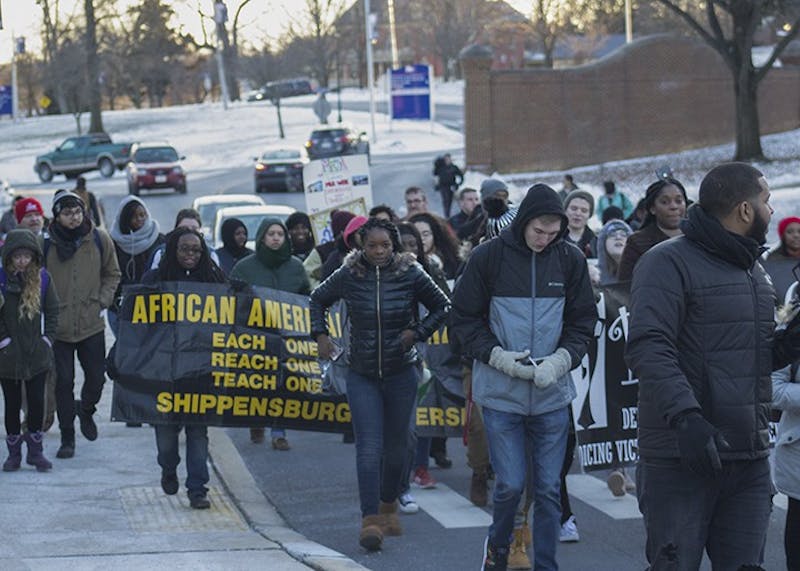 Students march on campus while holding banners and signs from their organizations during the March for Humanity. The march followed a ceremony with speakers including Pennsylvania state Sen. Vincent Hughes. This was the 32nd anniversary of the march, which was created to honor Martin Luther King Jr.