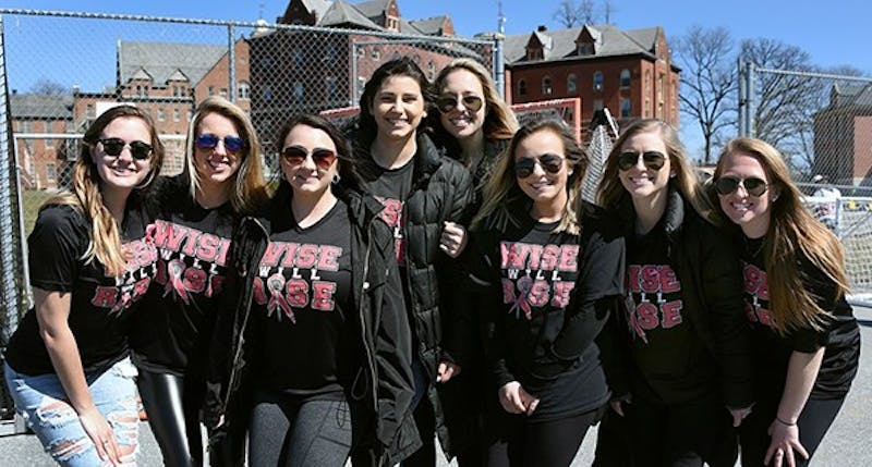 Julia Wise (center), a former member of the lacrosse team, was diagnosed with breast cancer last year and the Raider community rallied around her ever since.&nbsp;