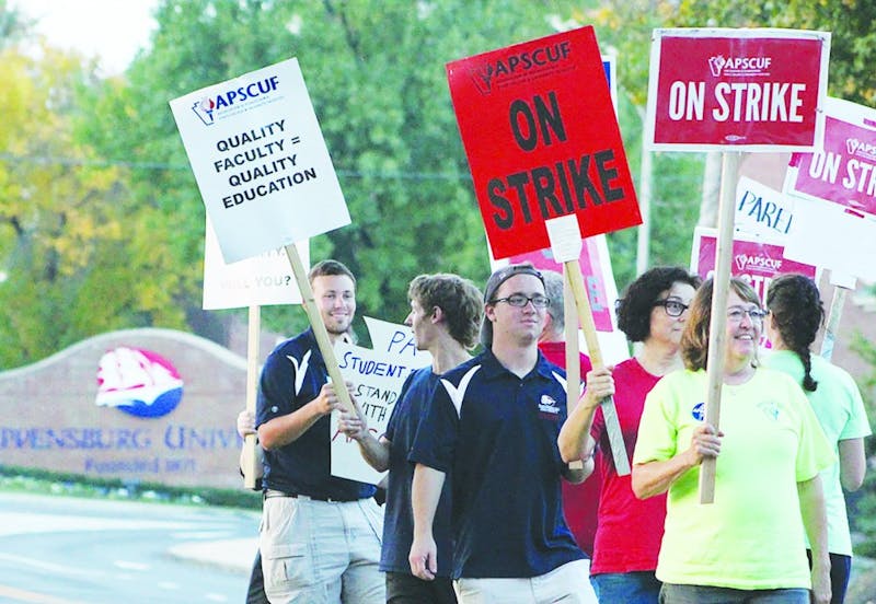 Shippensburg University students and faculty picket on North Prince Street near Old Main.