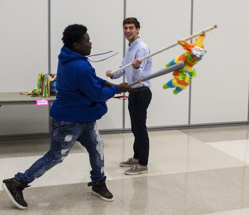 Jaylin Duprey takes a swing at the piñata during the Beat the Stress event.