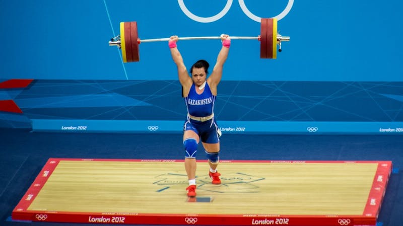 A weightlifter from Kazakhstan strikes a pose during a competition during the 2012 Olympics in London.