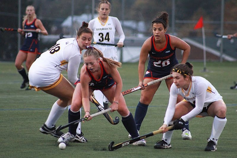 Freshman Paige Bond battles for possession against two Marauders alongside Raider teammate Jazmin Petrantonio