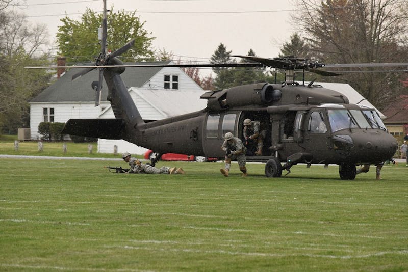 SU cadets sprint from a Blackhawk helicopter, which landed right in front of audience members at Thursday’s demonstration. The Blackhawk helicopter is used by the U.S. Army.