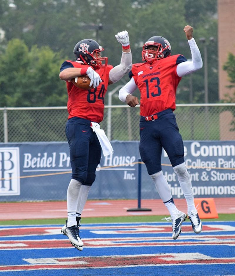 Shippensburg University’s Kyle Haines, left, and Winston Eubanks, right, celebrate after Haines’ 33-yard touchdown reception in the second quarter of SU’s 41-7 thrashing of American International on Saturday.&nbsp;