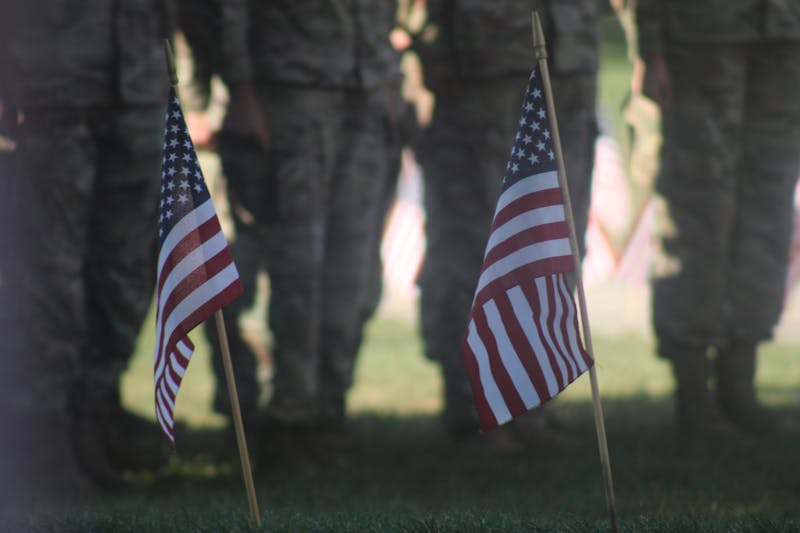 Service members of the Shippensburg University Raider Battalion stand on the quad outside of the Lehman Memorial Library.