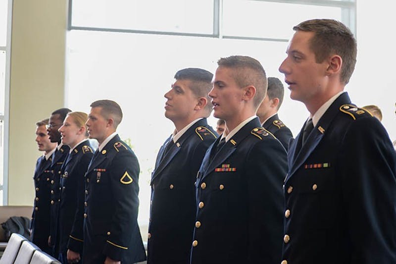 ROTC cadets stand at attention as the national anthem and “The Army Goes Rolling Along” are played.