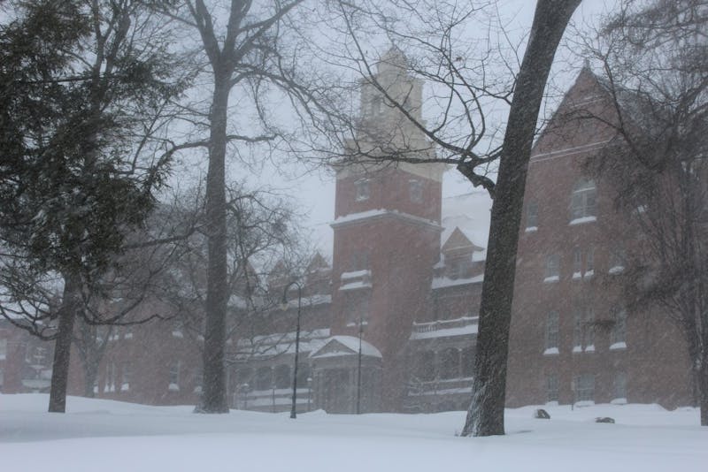 A barrage of snow hits the hill of Old Main and covers the roads and walkways leading to it.