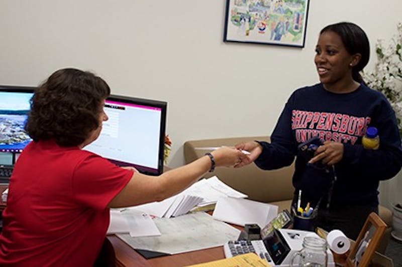 Scholarship recipient Miranda White receives a $500 check.&nbsp;