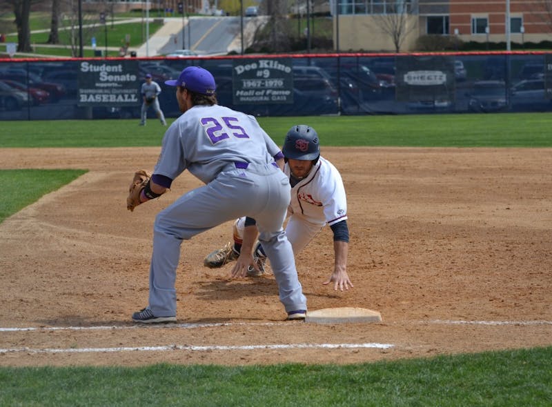 	Michael Douglas dives back to the bag after the WCU pitcher tries a pickoff attempt. 