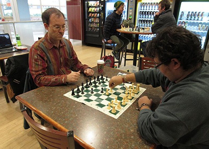 SU&nbsp;Chess Club adviser Dave Kennedy (left) plays a match with a student in Dauphin Humanities Center.