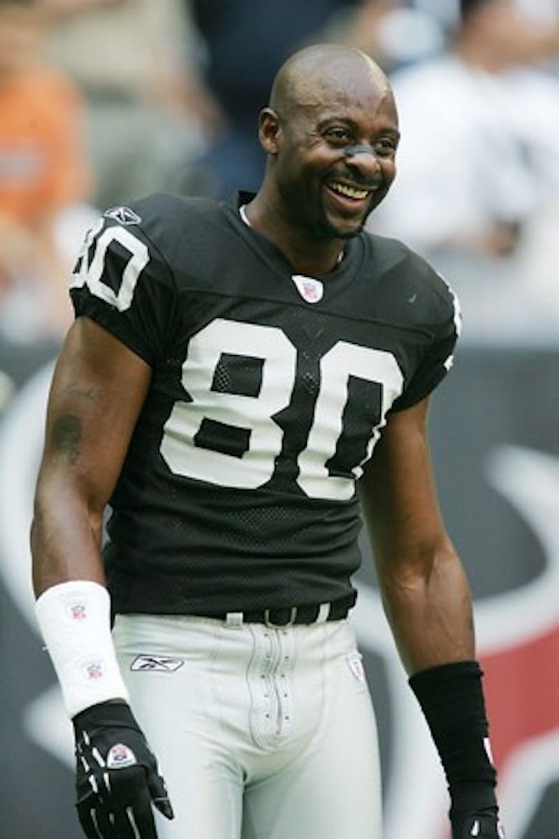 HOUSTON - OCTOBER 3: Jerry Rice #80 of the Oakland Raiders laughs on the sidelines before facing the Houston Texans on October 3, 2004 at Reliant Stadium in Houston, Texas.   (Photo by Ronald Martinez/Getty Images)