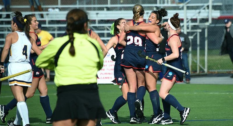 The field hockey team celebrates scoring one of its four goals in Sunday’s playoff victory over Merrimack.