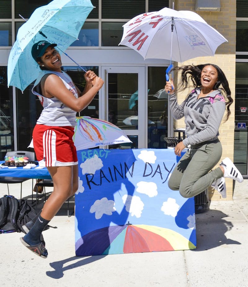 Students channel their inner Mary Poppins during umbrella decorating, honoring RAINN Day.