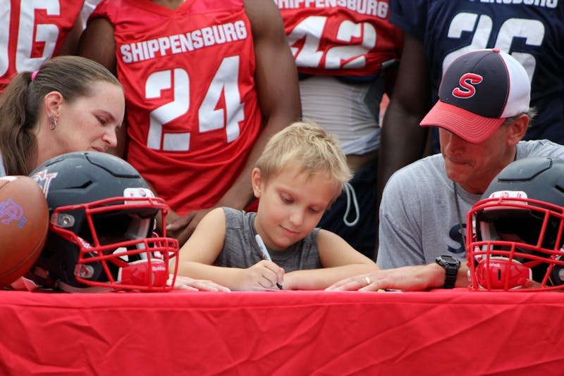 Six-year-old Gunnar Downie of Chambersburg signs a letter of intent to become a member of the SU football team. This was made possible by the Friends of Jaclyn Foundation, which helps children with pediatric cancer.