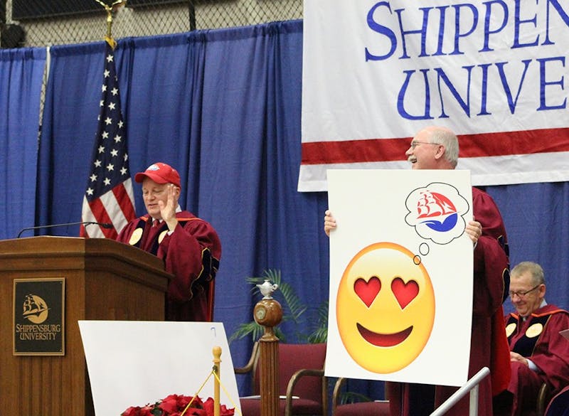 Doug Harbach tells students to never be afraid to show their Raider pride. SU President&nbsp;George "Jody" Harpster adds to Harbach's speech by holding up posters of emoticons.