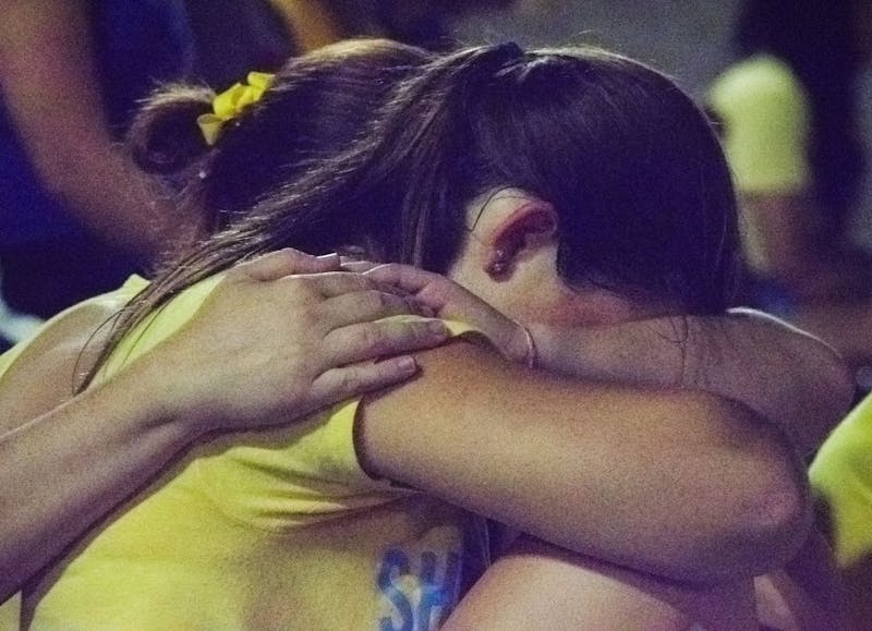 Student gets emotional during the moment of silence held at the suicide vigil.