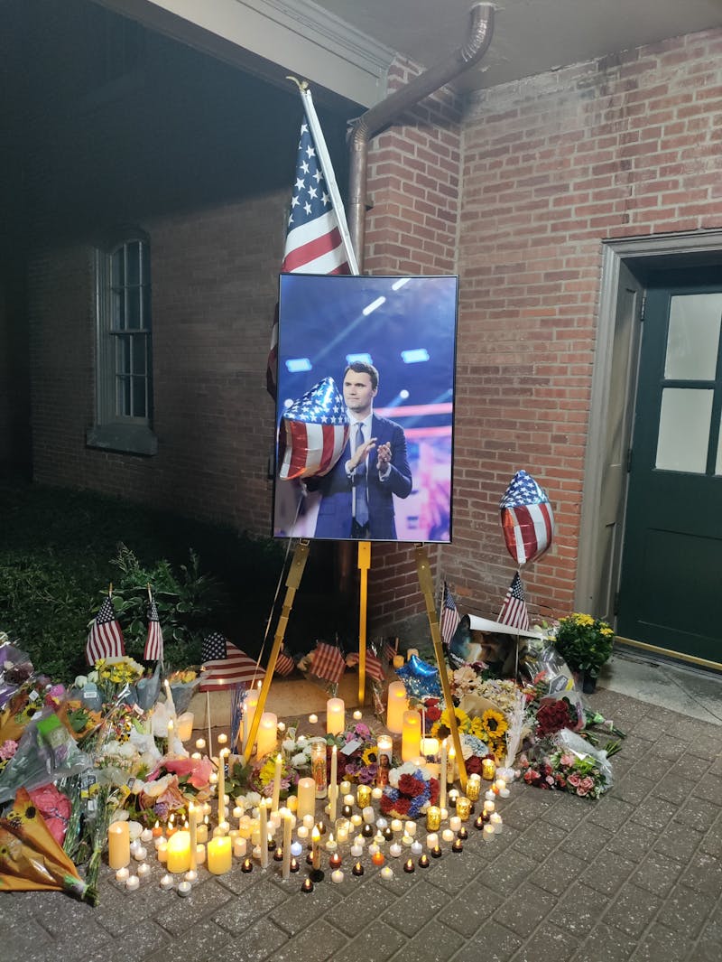 Candles were lit and U.S. flags were left by dozens of attendees at Thursday’s vigil for Charlie Kirk.