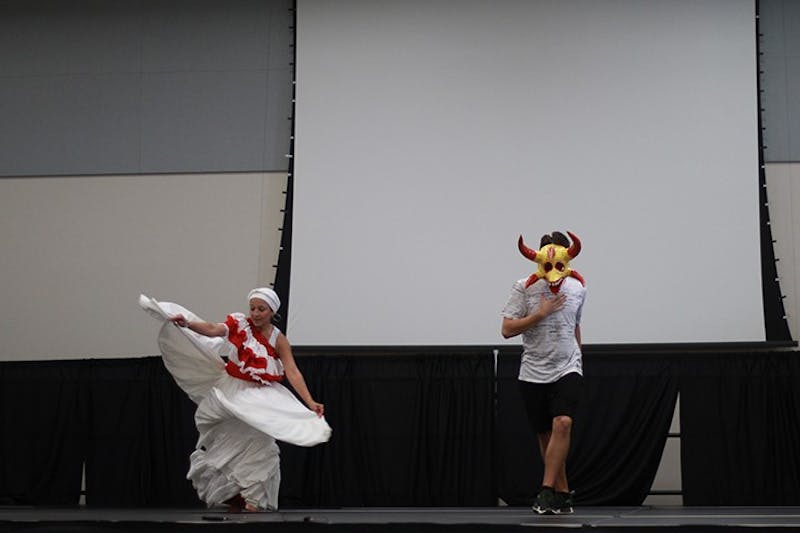 Wnada Holdren and SU student Ryan Krueger prepare to dance a traditional Puerto Rican dance on stage. All audience members were invited to learn steps for salsa dancing. The dance lessons followed a lecture given by Holdren, who has been dancing since she was 6 years old and owns her own dance academy.