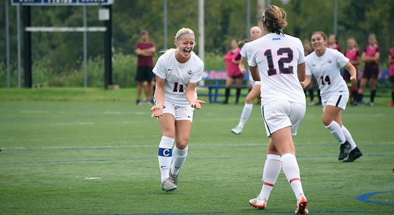 Beth McGee, wearing No. 11, celebrates with teammates after scoring her first goal of the season in the 10th minute of SU’s 3–2 win over Gannon.