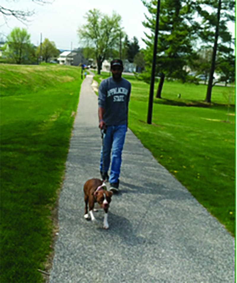 Shippensburg University student walks his dog to relieve studying stress.