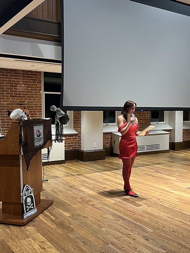 The Reflector PR Director Tomi May reads at the open mic night.