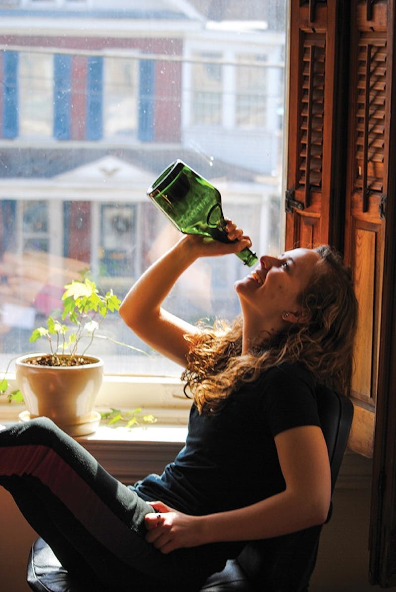 Natalie Eastwood models how people would have once drank from a Benedictine liquor bottle, a treasure she found on an adventure.