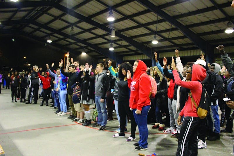 Students raised their hands in agreement with the personal growth challenges Martin Worthy assigned them for personal growth.