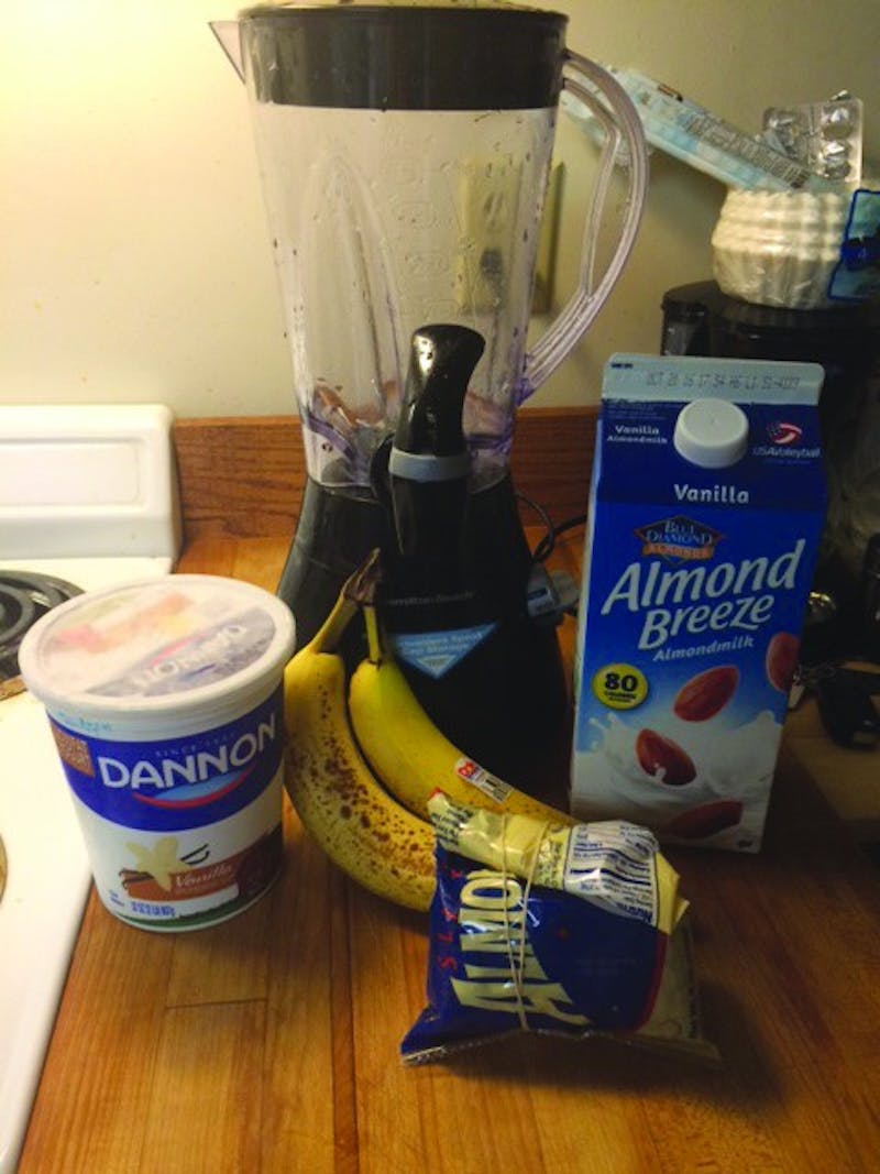 The ingredients for the protein shake include items such as yogurt, bananas, almond milk, any sort of nuts and a blender to mix it all up.