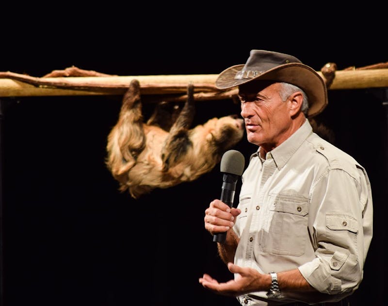 Jack Hanna explains the natural habitat and behavior of the two-toed sloth,&nbsp;Slowpoke, as it hangs upside down on a log stand. (Below) A bearcat wanders on a display table. The bearcat has one of the strongest tails in the animal kingdom, according to Hanna.