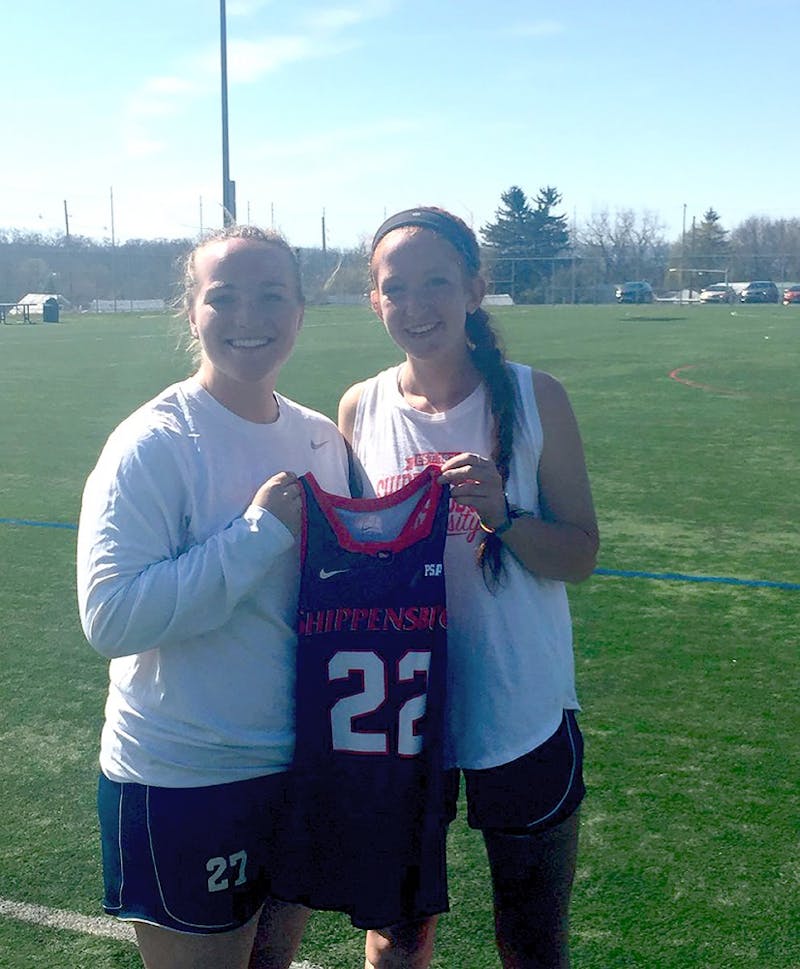 Ally Mooney, left, poses with Amanda Strous’ jersey and last year’s scholarship recipient, Brooke Sheibley, right. Mooney will wear the No. 22 jersey in 2018.