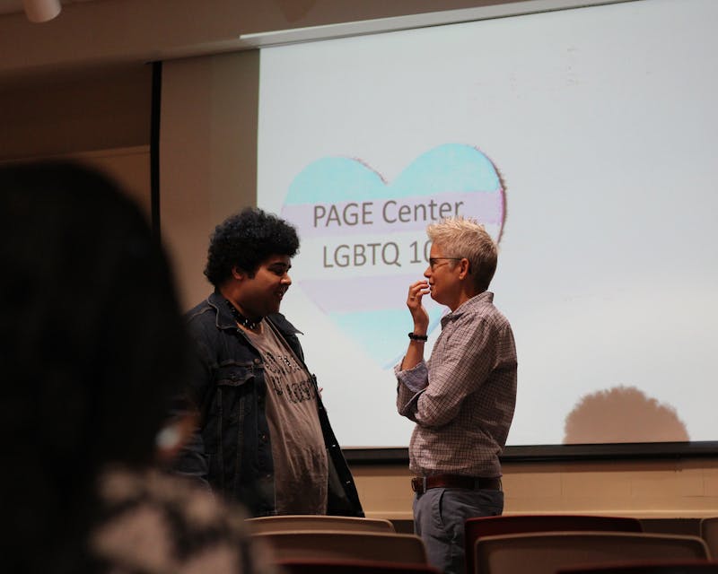 PAGE Center Director Miller Hoffman speaks to a student before the event.