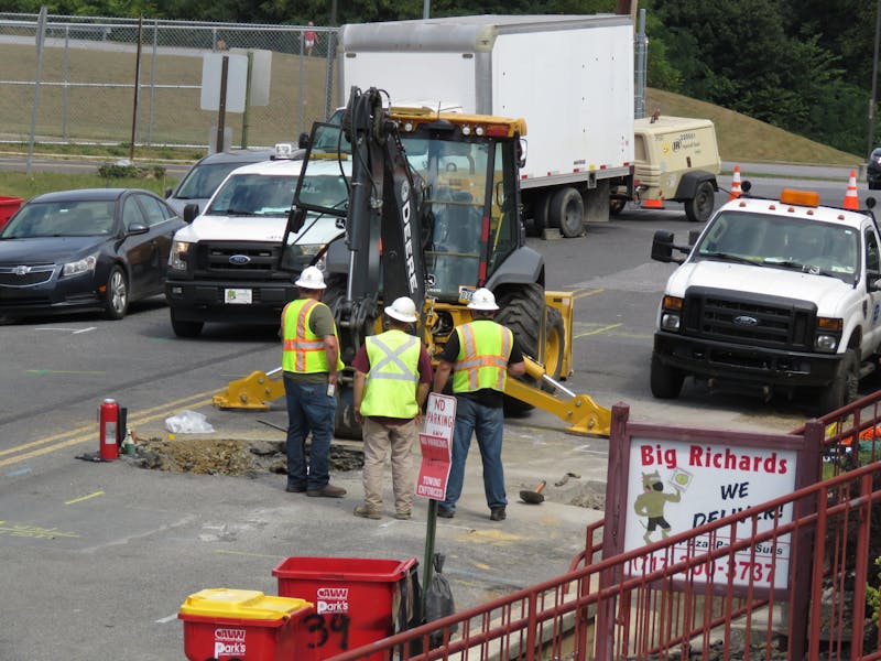 Repair crews work to fix the damaged piping and roads along Richard Avenue.