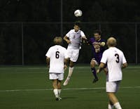 Senior Ashton Davies goes for a header against West Chester. Davies scored the first goal of the match, propelling SU to a conference win.