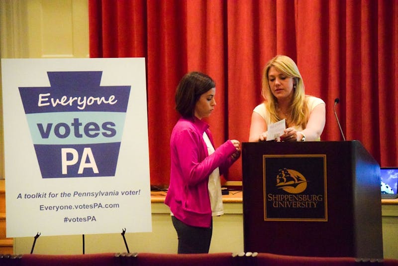 Melissa Frey talks to a student on Wednesday about registering to vote.