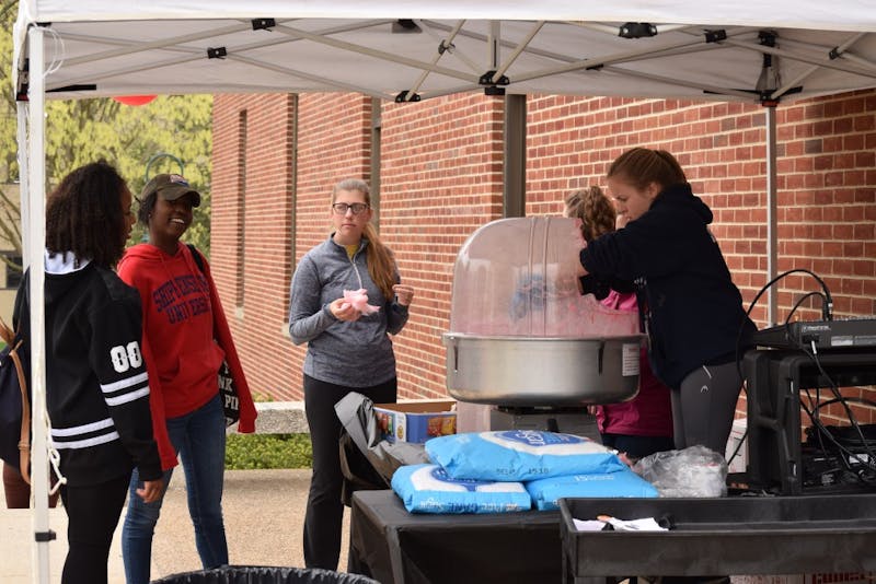 Students stop outside the library for a sweet treat of cotton candy before heading off to study for finals.