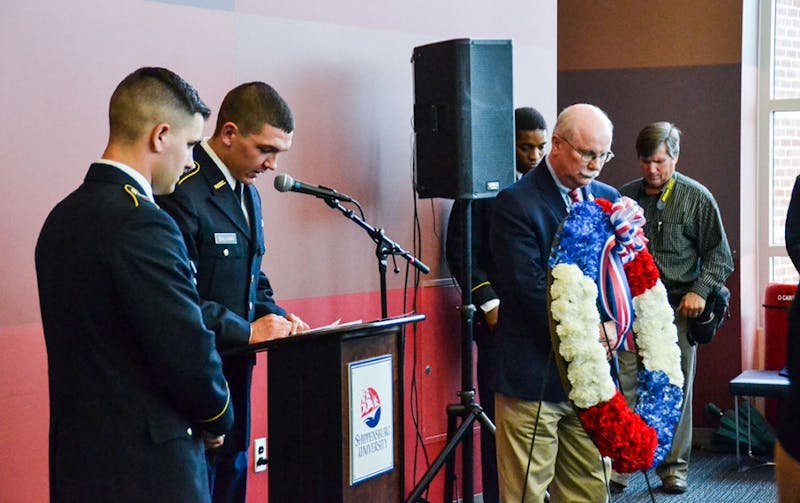 SU President Jody Harpster presents the traditional wreath in honor of armed services members during the ceremony.