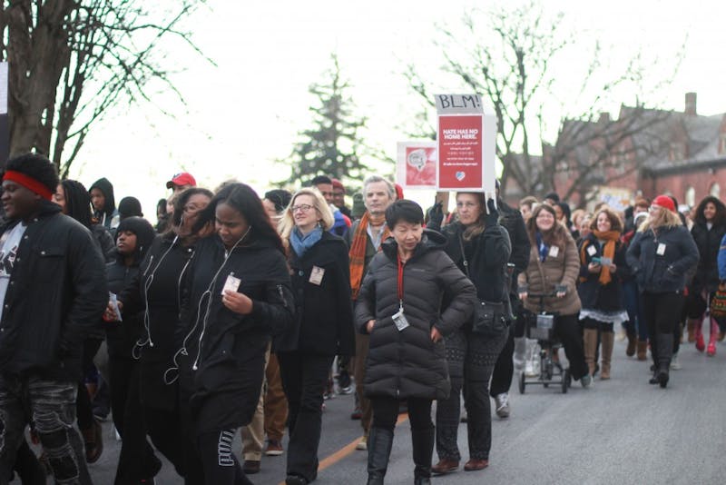 Students, faculty and community members march from SU’s Old Main Chapel to the Tuscarora Room in Reisner Dining Hall, where light refreshments were offered to all attendees.