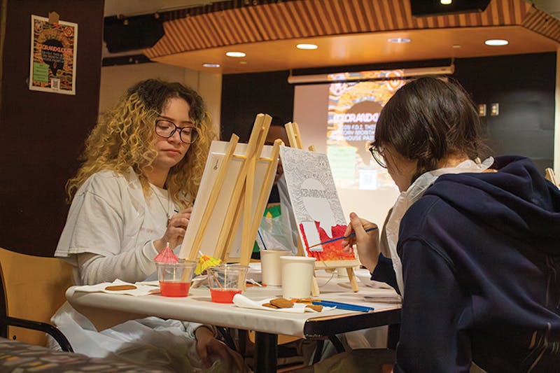 SU students paint at the FDI "Culture and Color" event.&nbsp;