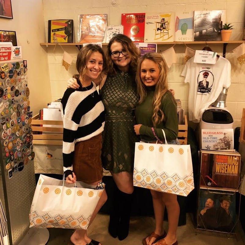 (Left to right) Halle Zullinger and Hannah Nawa stand with Kassidy Carbaugh, who won the raffle. Carbaugh received a gift bag and a discount.&nbsp;