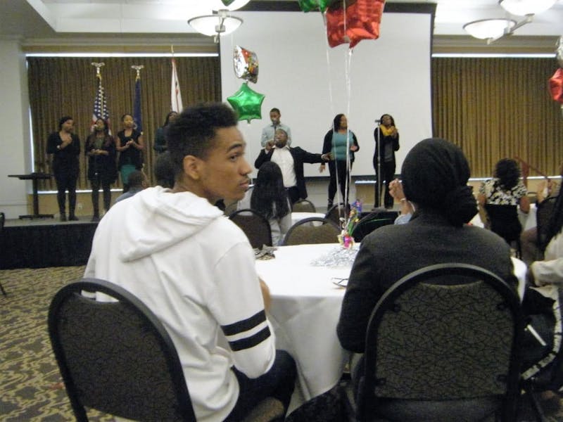 The audience applauds the student and alumni singers in the Tuscarora Room.