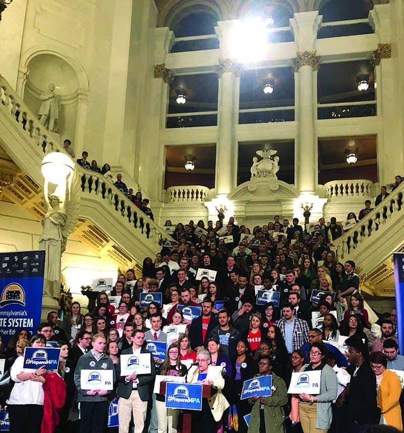 Students gather on the stairs in the Capitol building’s rotunda while speakers including Interim Chancellor Karen M. Whitney and SU President Laurie Carter deliver speeches. Carter emphasized her experience at Clarion University and how it prepared her future and how she feels a connection to students at SU.