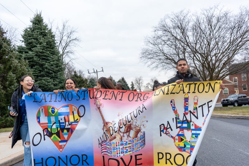 Members of the Latino Student Organization walk with their banner held high at the 36th Annual MLK March for Humanity.