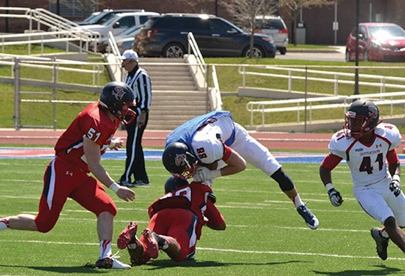 D.J. Brinkley puts a hit on Chris Figler in the first quarter of Saturday's action.